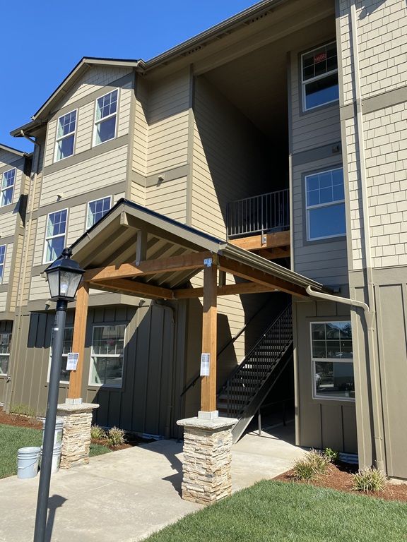 Curved handrail apartment complex front view image The Grove